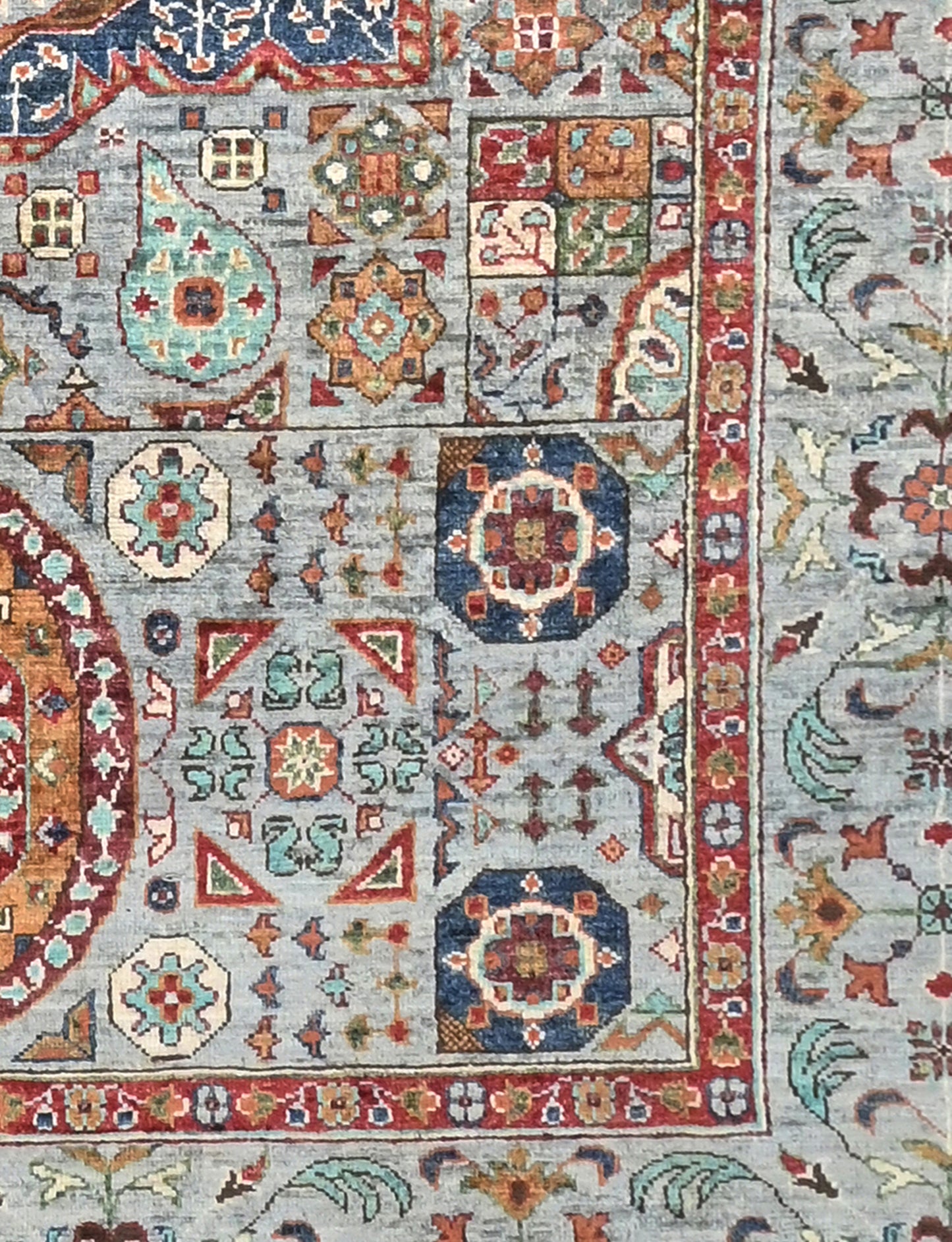 Close-up of a patterned rug with intricate designs in various colors.