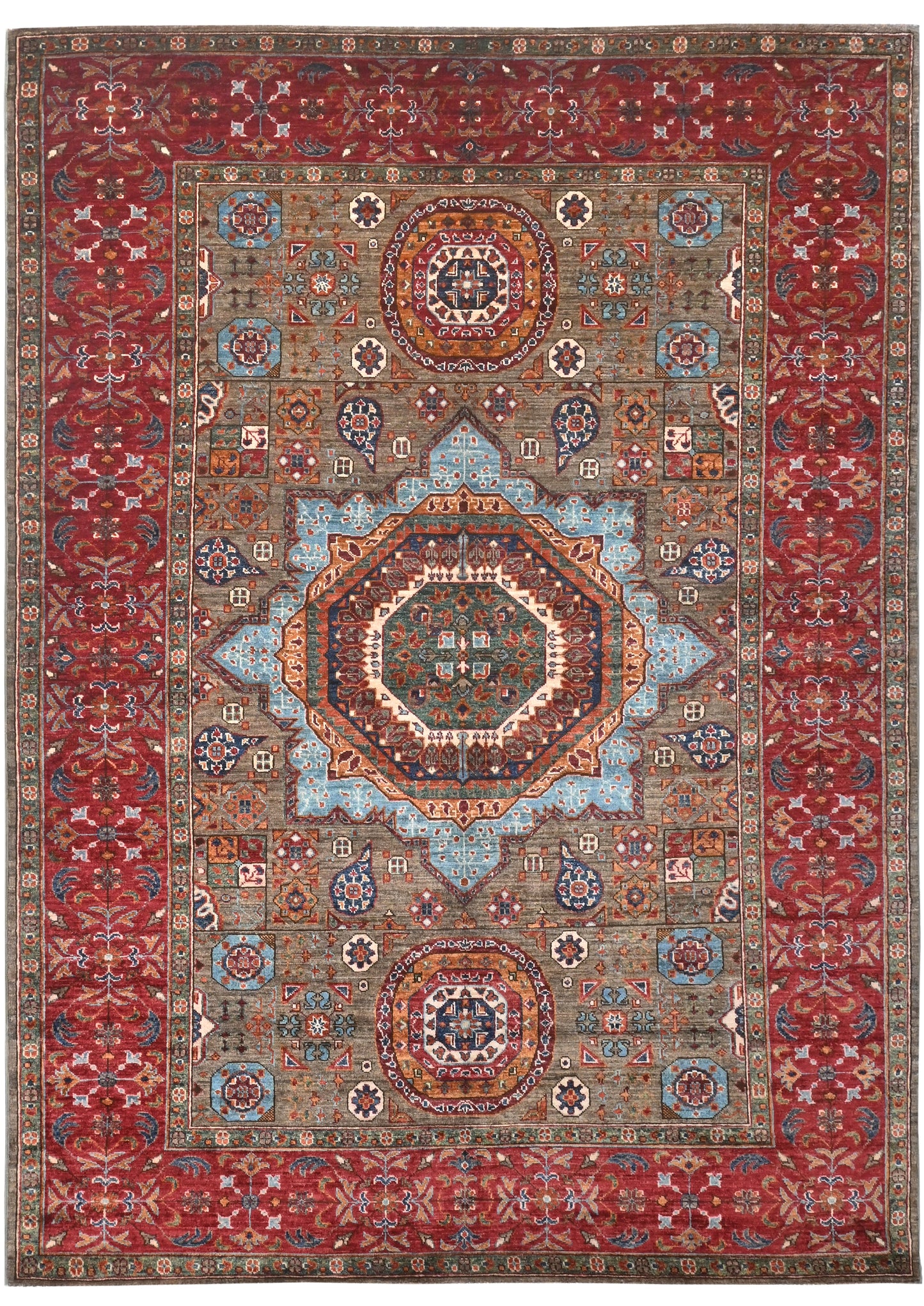 Decorative rug with intricate patterns and a central medallion on a red background