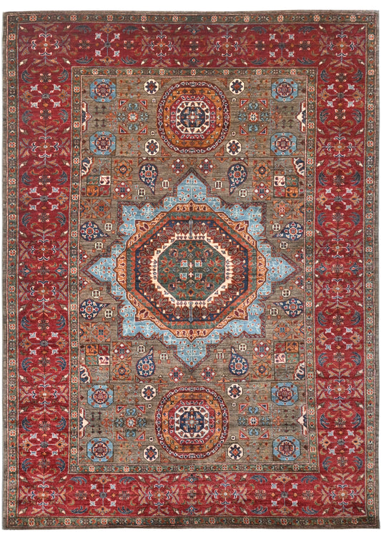 Decorative rug with intricate patterns and a central medallion on a red background