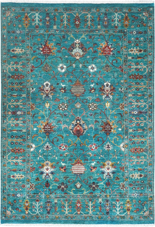 Decorative rug with intricate patterns on a blue background
