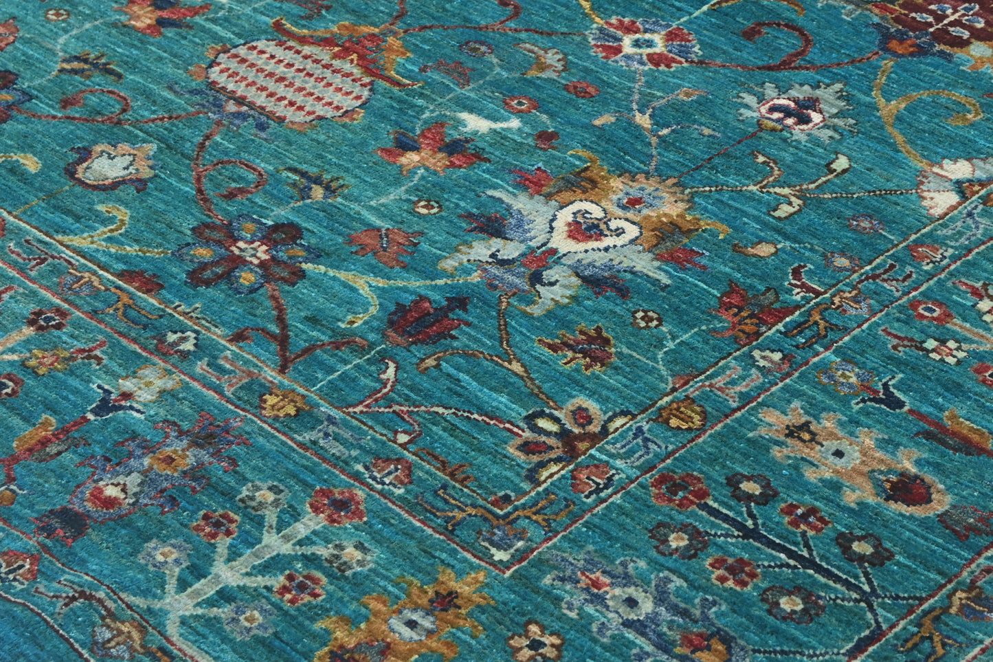 Close-up of a patterned rug with floral designs on a blue background