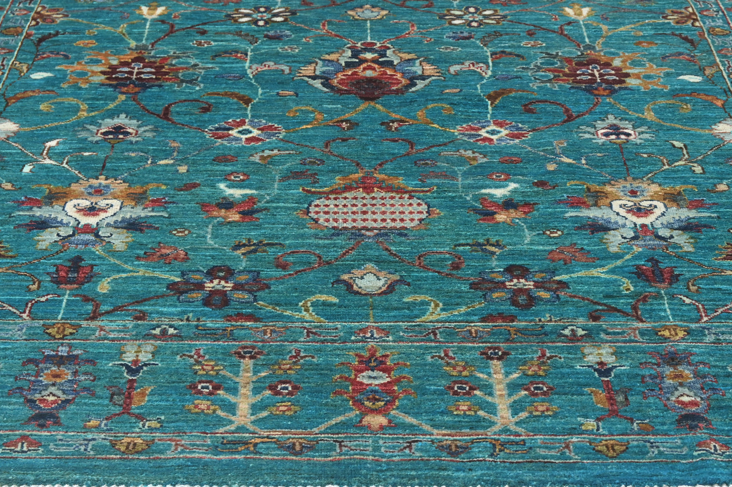 Decorative rug with intricate patterns on a blue background