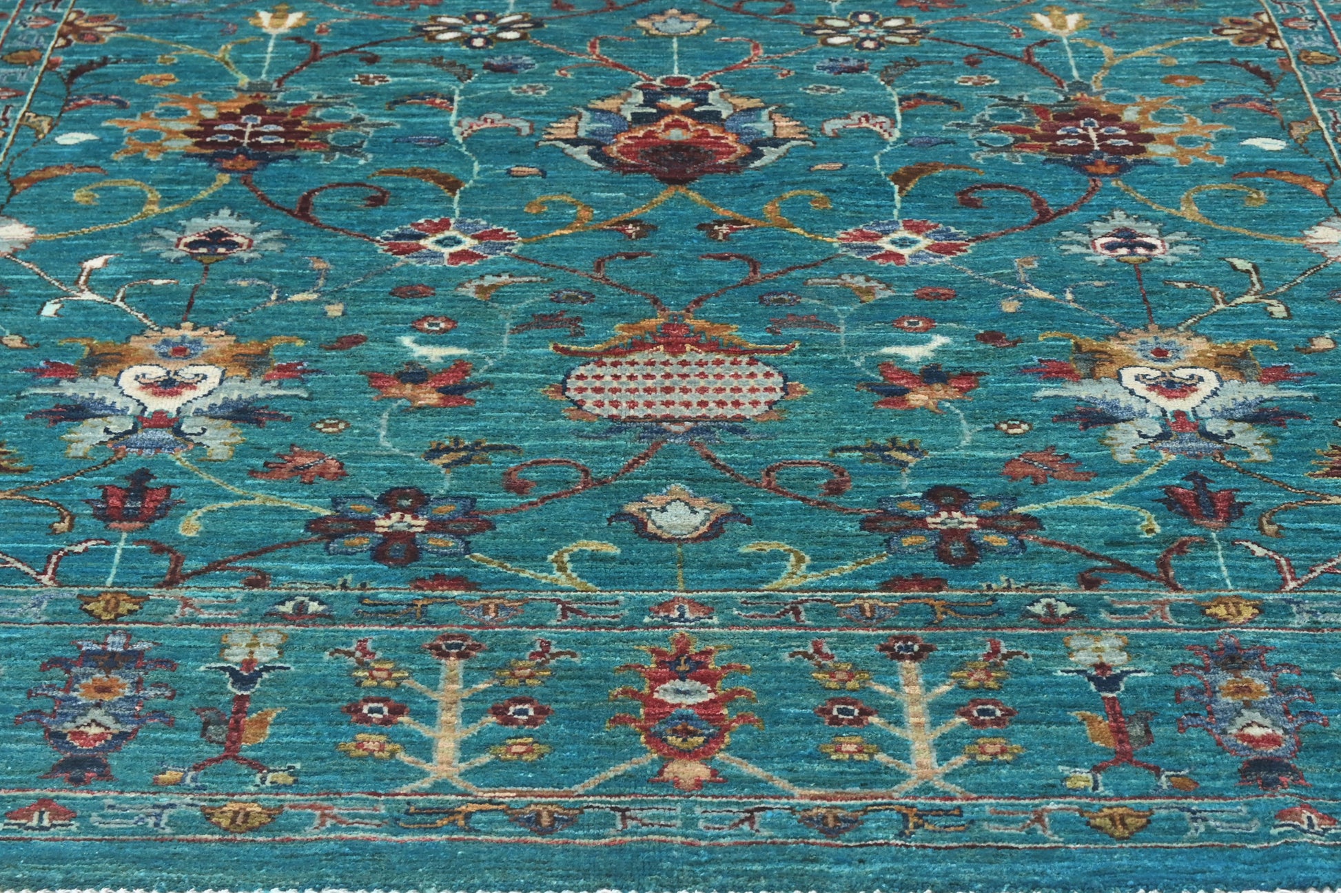 Decorative rug with intricate patterns on a blue background