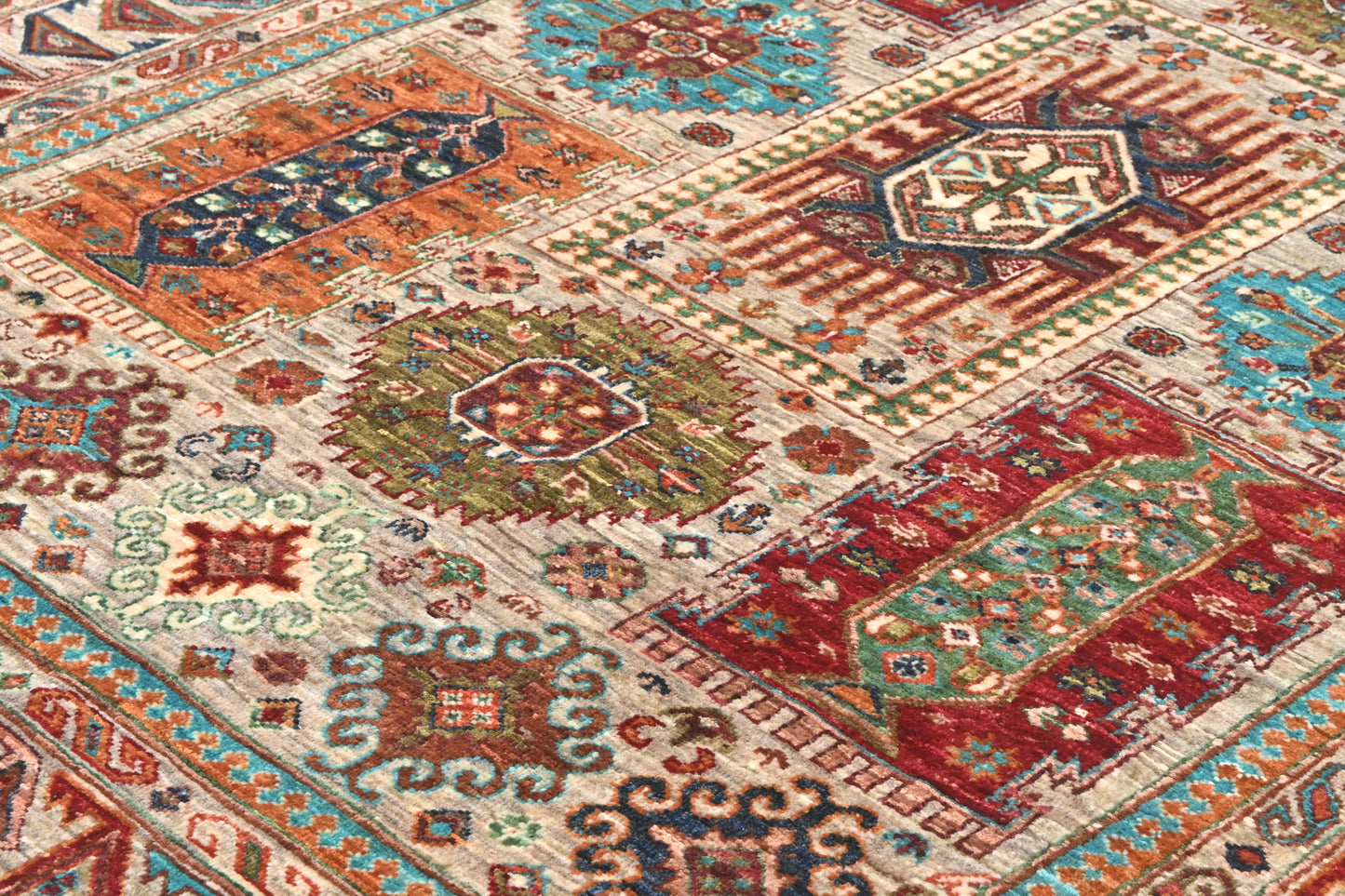 Close-up of a patterned rug with intricate designs in various colors.