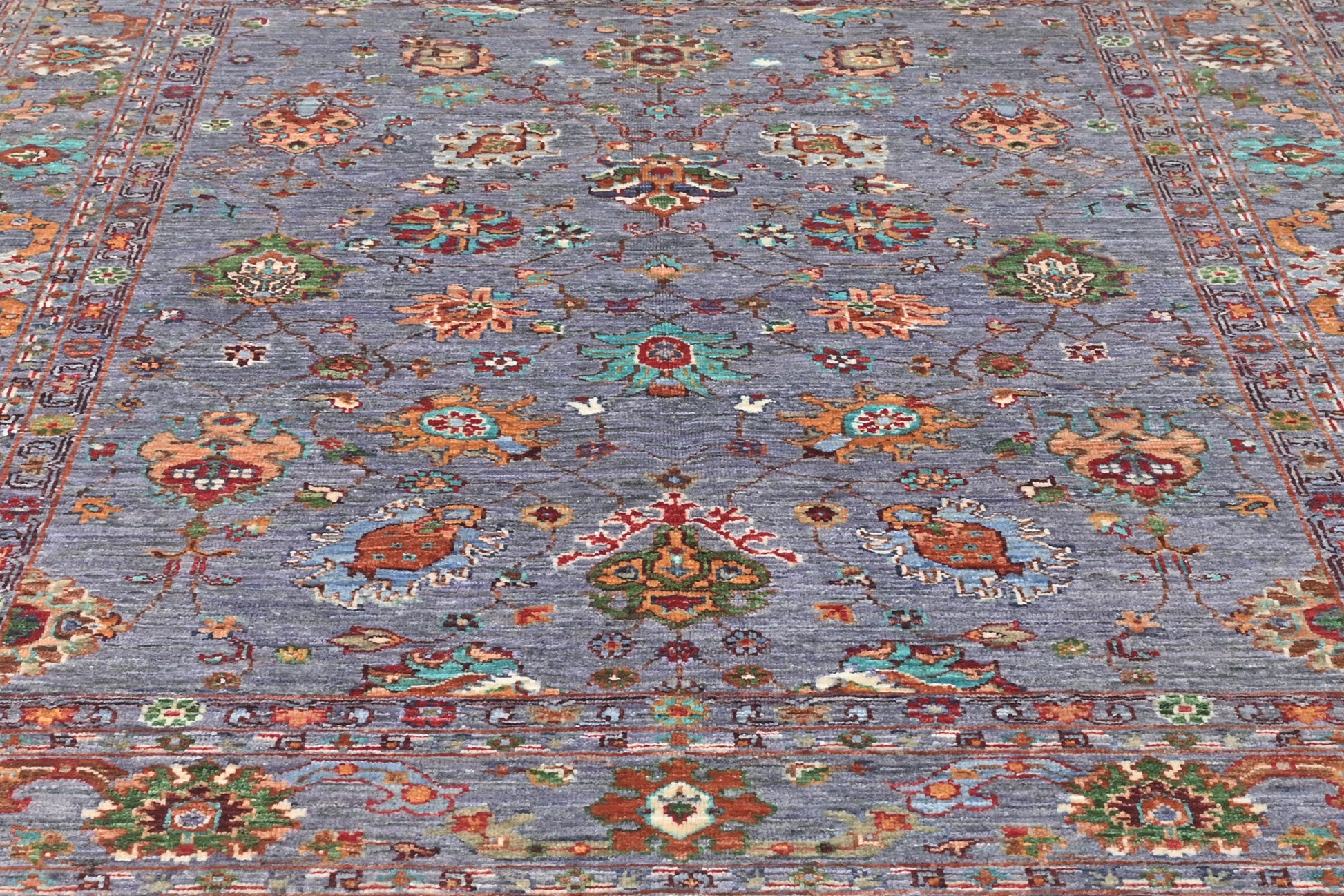 Decorative rug with intricate patterns on a blue background