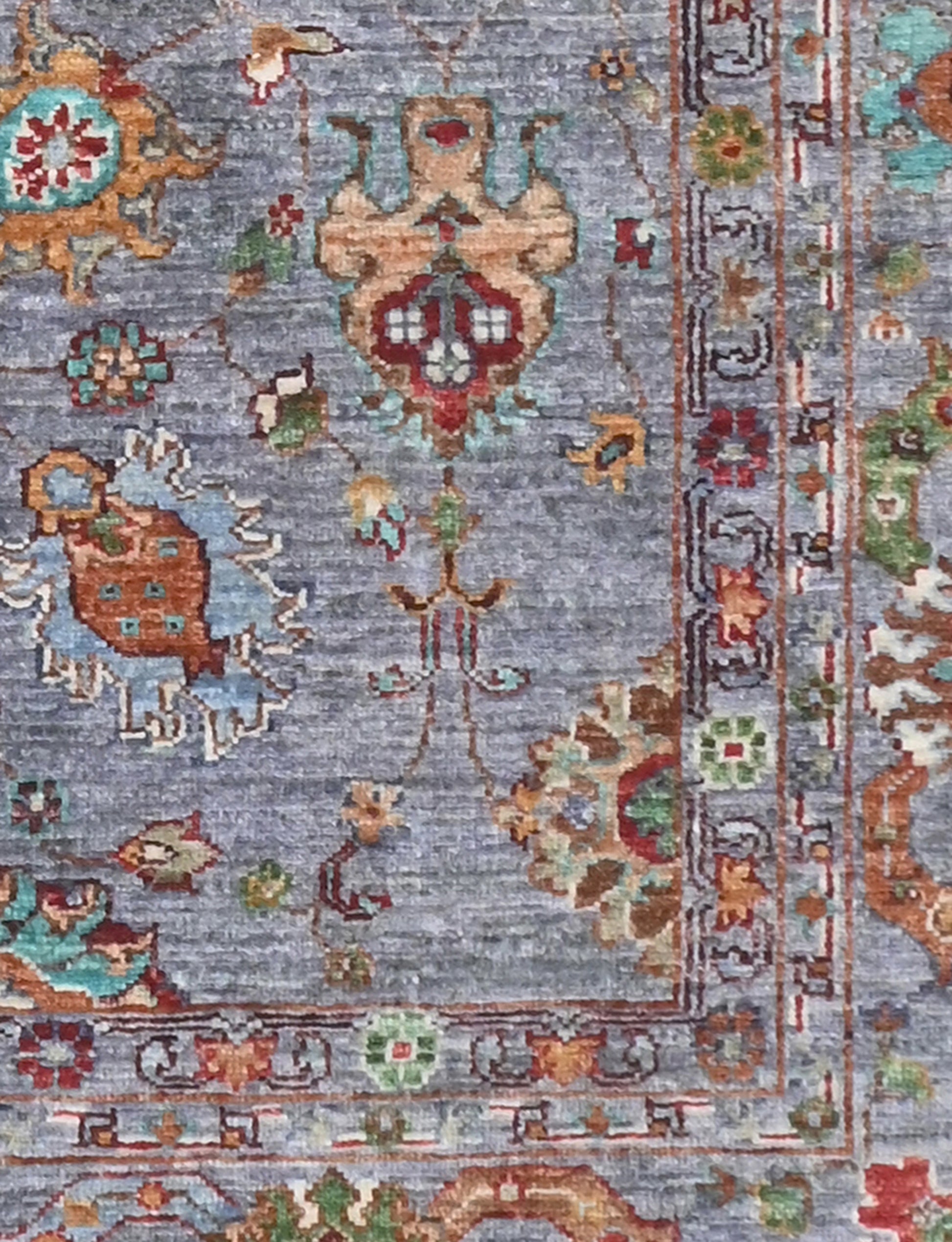 Decorative rug with intricate patterns and colors on a blue background