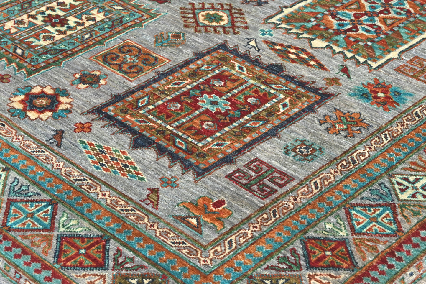 Close-up of a patterned rug with geometric designs in various colors.