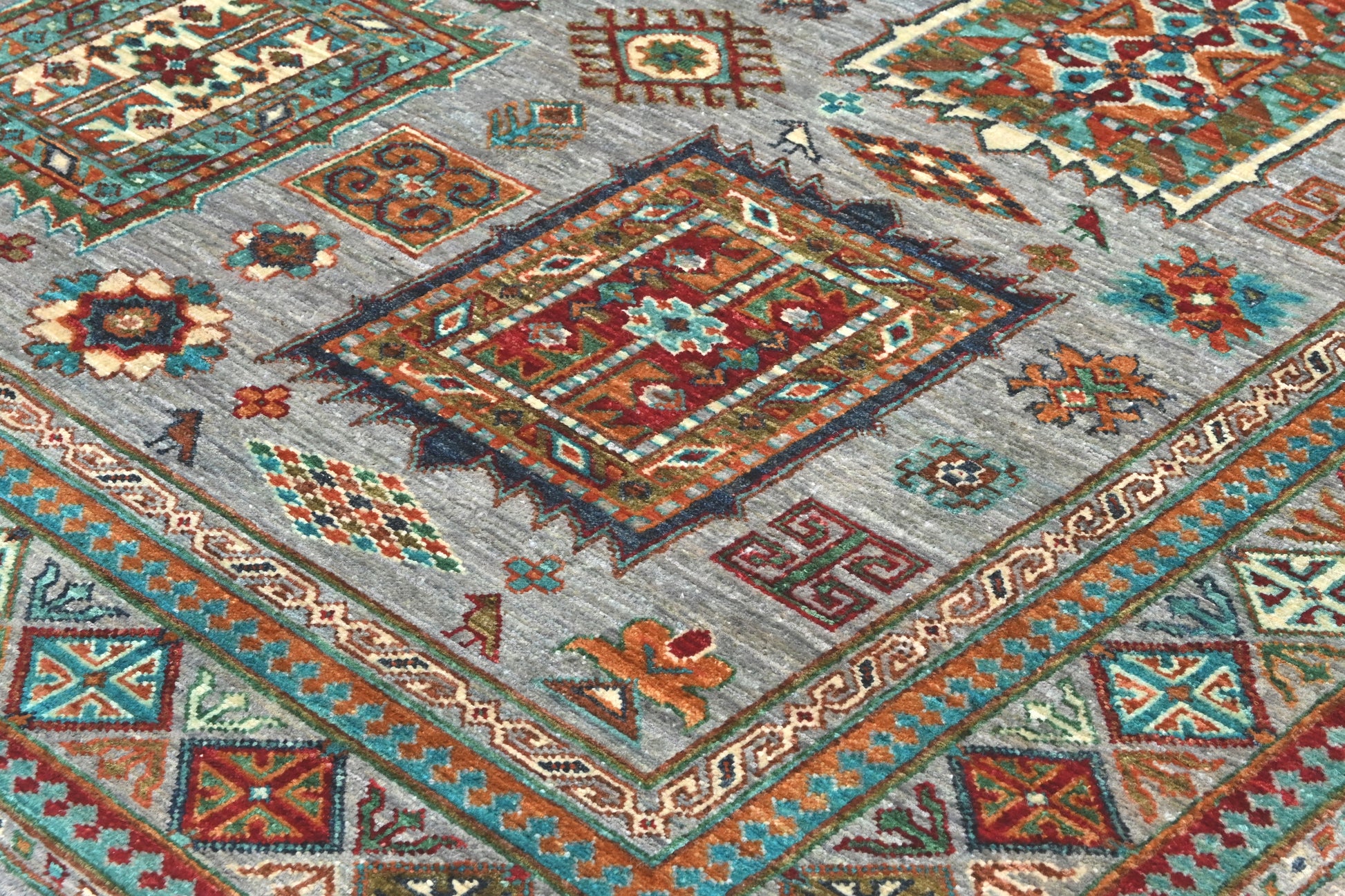 Close-up of a patterned rug with geometric designs in various colors.