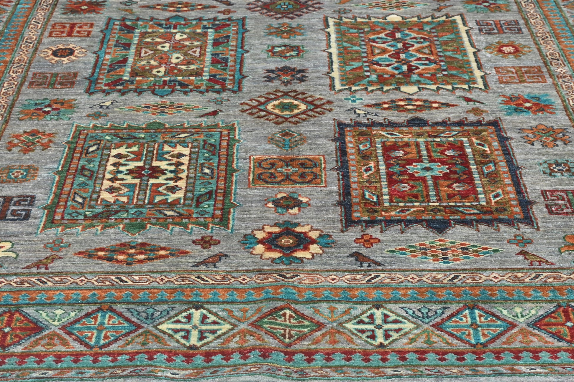 Close-up of a patterned rug with geometric designs in various colors.