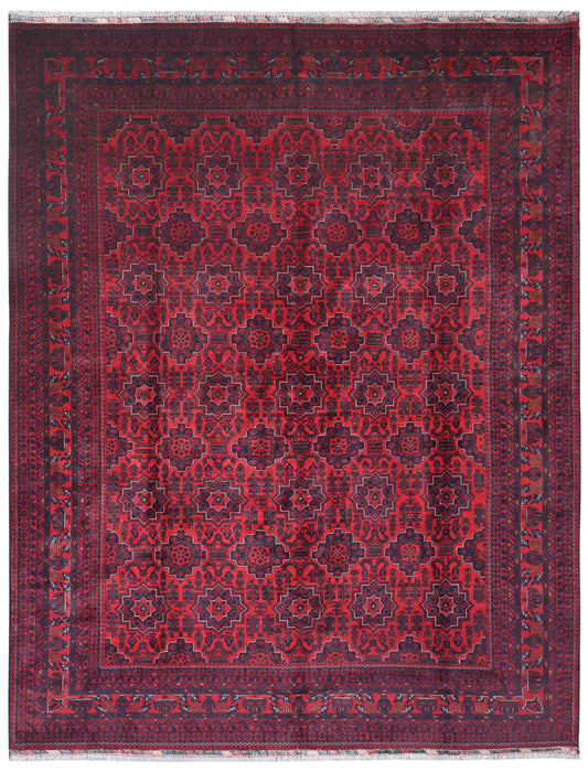 Red patterned rug with intricate design on a white background