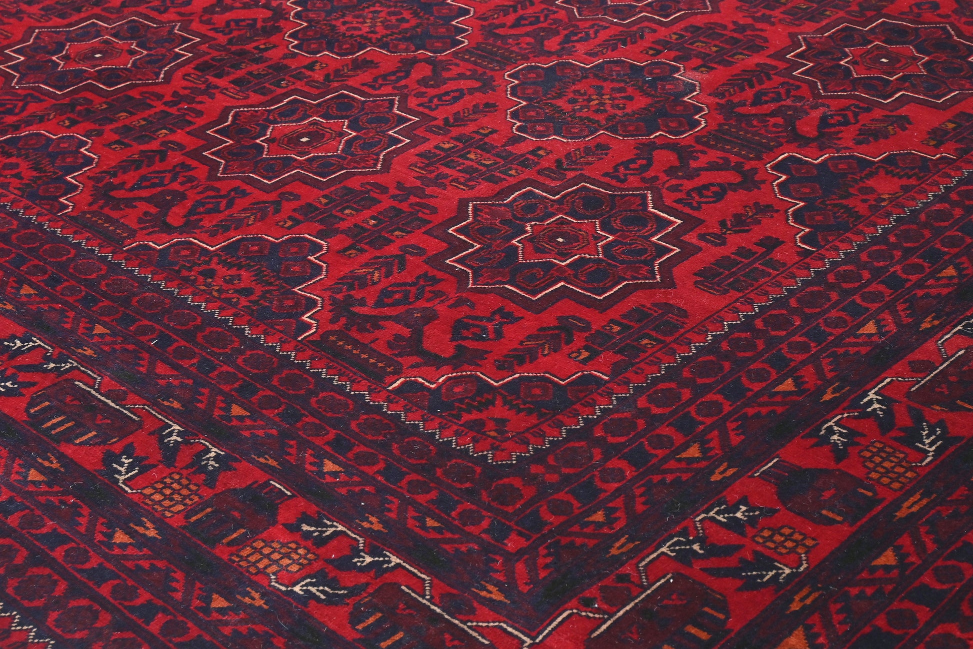 Close-up of a red patterned fabric with intricate designs