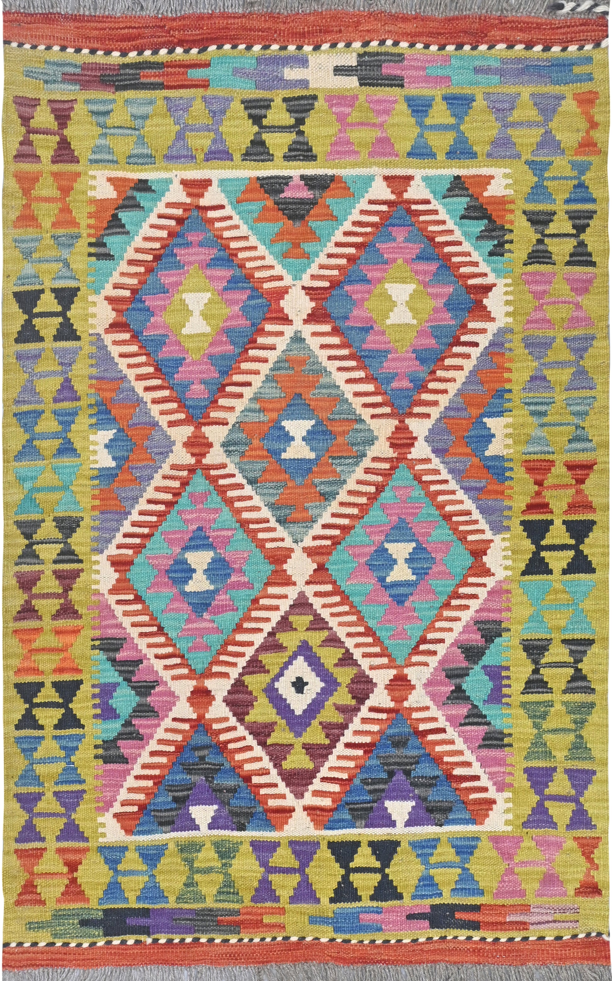 Multicolored geometric patterned rug with vibrant colors on a plain background