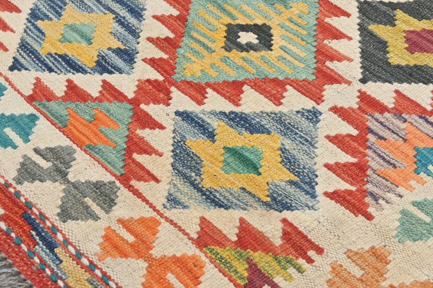 Close-up of a colorful patterned rug with geometric designs.