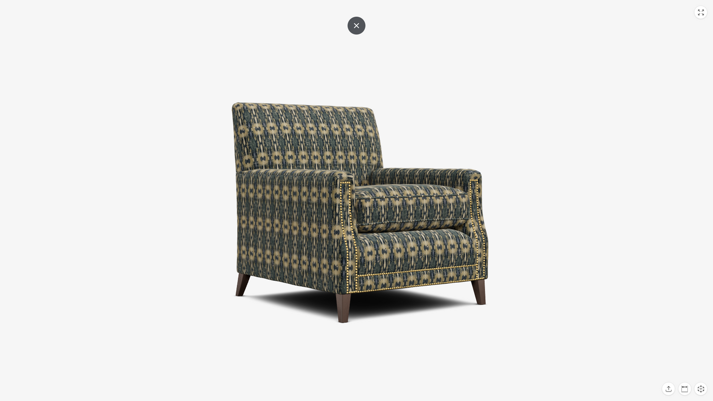A single upholstered armchair with a geometric patterned fabric in muted green, beige, and gray tones, shown on a plain light gray background.