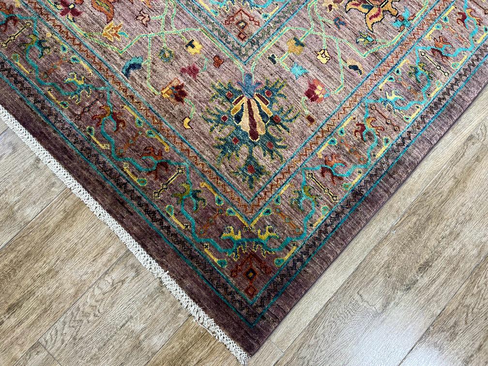 Decorative rug with intricate patterns on a wooden floor