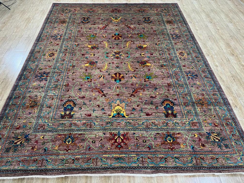 Decorative rug with intricate patterns on a wooden floor