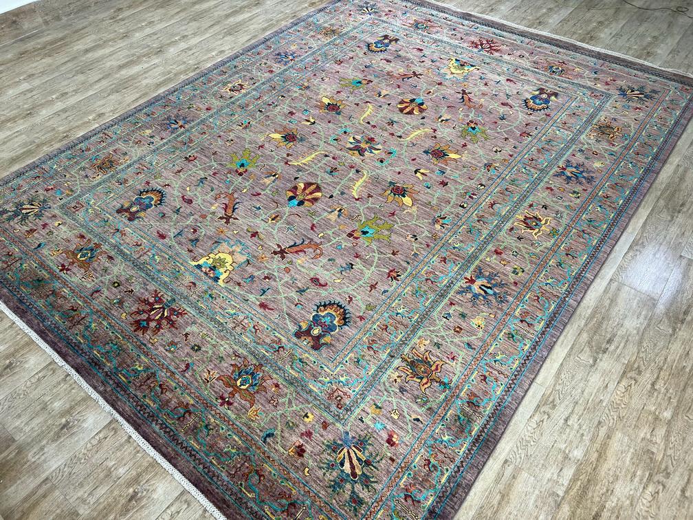 Decorative rug with intricate patterns on a wooden floor